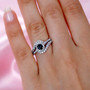 indicolite tourmaline and white zircon halo ring in rhodium over sterling silver worn on a hand