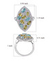 sphene apatite and moissanite statement ring in rhodium over sterling silver shown for size comparison
