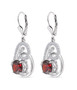 side view of garnet and moissanite heart dangle earrings in rhodium over sterling silver