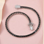 black diamond round tennis bracelet in black and white rhodium over sterling silver shown in a lifestyle photo