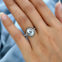 aquamarine champagne and white diamond halo ring in rhodium over sterling silver worn on a hand