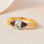 aquamarine and rhodolite garnet ring in 18k yellow gold over sterling silver shown in a lifestyle photo