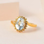 aquamarine and yellow sapphire halo bypass ring in 18k yellow gold over sterling silver shown in a lifestyle photo