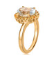 side view of aquamarine and yellow sapphire halo bypass ring in 18k yellow gold over sterling silver