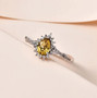 heliodor and white zircon pear halo ring in rhodium over sterling silver shown in a lifestyle photo