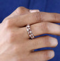 pink tourmaline and moissanite band ring in 18k rose gold and rhodium over sterling silver worn on a hand