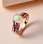 ethiopian opal pink sapphire and white zircon bridge ring in 18k rose gold over sterling silver shown in a lifestyle photo