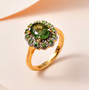 green apatite tsavorite garnet and moissanite halo ring in 18k yellow gold over sterling silver shown in a lifestyle photo