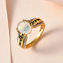 ethiopian opal chrome diopside and white zircon bridge ring in 18k yellow gold over sterling silver shown in a lifestyle photo
