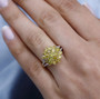 yellow diamond and white diamond cluster ring in 10k yellow gold worn on a hand