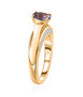 side view of tanzanite and white zircon solitaire ring in 18k yellow gold over sterling silver