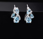 sky blue topaz and white zircon stud earrings in rhodium over sterling silver