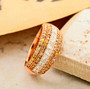 multi color and white diamond cluster band ring in 14k rose gold shown in a lifestyle photo