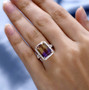 ametrine and moissanite halo ring in 10k yellow gold worn on a hand