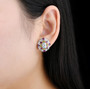 sky blue topaz and multi gemstone cluster stud earrings in rhodium over sterling silver worn on the ear