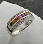 multi color sapphire and white zircon band ring in rhodium over sterling silver shown in a lifestyle photo