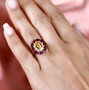 heliodor rhodolite garnet and moissanite halo ring in 18k rose gold over sterling silver worn on a hand