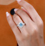 aquamarine and diamond halo ring in 950 platinum worn on a hand