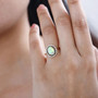 opal multi and white diamond halo ring in 18k yellow gold over sterling silver worn on a hand