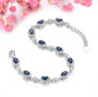 close up of sapphire and white zircon halo bracelet in rhodium over sterling silver
