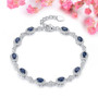 sapphire and white zircon halo bracelet in rhodium over sterling silver shown in a lifestyle photo