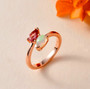 pink tourmaline and ethiopian opal pear bypass ring in 18k rose gold over sterling silver shown in a lifestyle photo