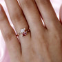 pink tourmaline and ethiopian opal pear bypass ring in 18k rose gold over sterling silver worn on a hand