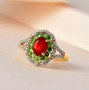 cherry fire opal tsavorite garnet and white zircon double halo ring in18k yellow gold over sterling silver shown in a lifestyle photo