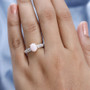 pink opal and white zircon ring in 18k rose gold over sterling silver worn on a hand