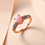 pink opal and white zircon ring in 18k rose gold over sterling silver shown in a lifestyle photo