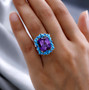 lab color change sapphire turquoise and apatite halo ring in rhodium over sterling silver worn on a hand