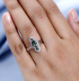 green apatite rhodolite garnet and zircon elongated ring in rhodium over sterling silver worn on a hand