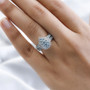 blue apatite and white zircon halo cluster ring in rhodium over sterling silver worn on a hand