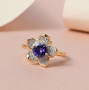 tanzanite and white zircon flower ring in 18k yellow gold over sterling silver shown in a lifestyle photo