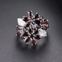 close up of black garnet and white zircon floral cluster ring in rhodium over sterling silver
