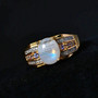 rainbow moonstone tanzanite and white zircon gents ring in 18k yellow gold over sterling silver shown in a lifestyle photo