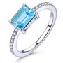 full view of london blue topaz white zircon and emerald cut solitaire ring in rhodium over sterling silver