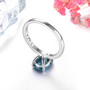 back view of oval london blue topaz and white zircon ring in rhodium over sterling silver