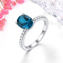 oval london blue topaz and white zircon ring in rhodium over sterling silver shown in a lifestyle photo