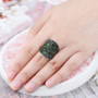 chrome diopside and black spinel cluster ring in black and white rhodium over sterling silver worn on a hand