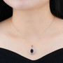 garnet and white zircon double halo pendant necklace in 18k rose gold over sterling silver worn around the neck