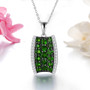 chrome diopside and white zircon cluster pendant necklace in black and white rhodium over sterling silver shown in a lifestyle photo