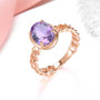 amethyst chain link solitaire ring in 18k rose gold over sterling silver shown in a lifestyle photo