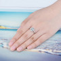 aquamarine and white zircon halo ring in rhodium over sterling silver worn on a hand