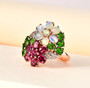 opal chrome diopside rhodolite garnet and zircon flower cluster ring in 18k rose gold over sterling silver shown in a lifestyle photo