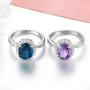 close up of womens natural london blue topaz and white zircon halo ring in rhodium over 925 sterling silver
