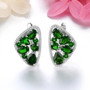 chrome diopside and white zircon earrings in rhodium over sterling silver shown in a lifestyle photo