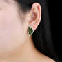 chrome diopside and white zircon earrings in rhodium over sterling silver worn on the ear