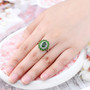 chrome diopside and white zircon halo ring in rhodium over sterling silver worn on a hand