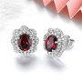 side view of rhodolite garnet and white zircon double halo stud earrings in rhodium over sterling silver